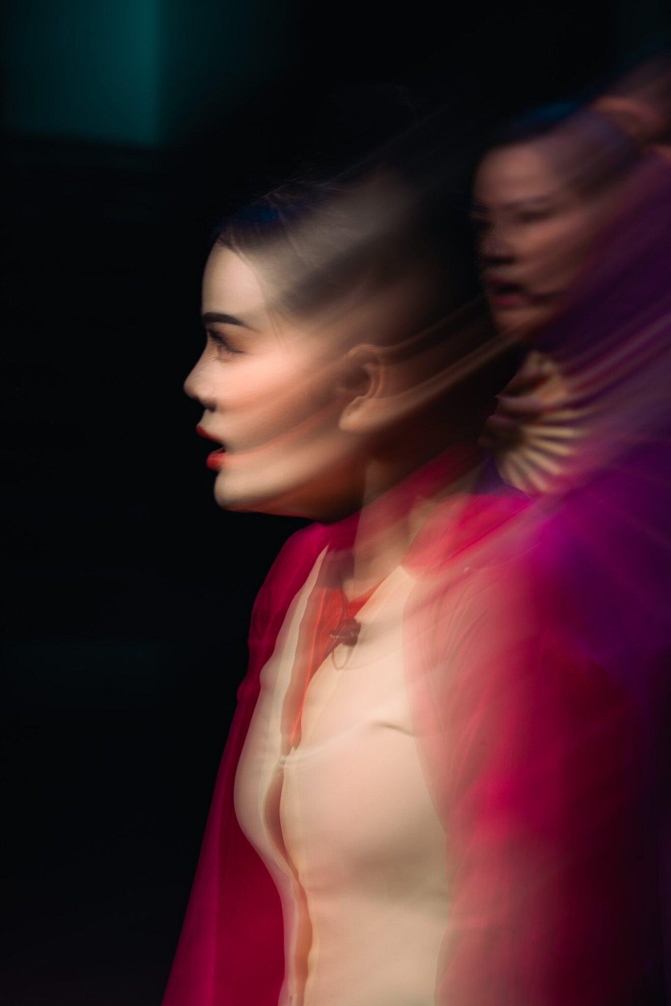 Profile of an actress in stage makeup, blurred by movement