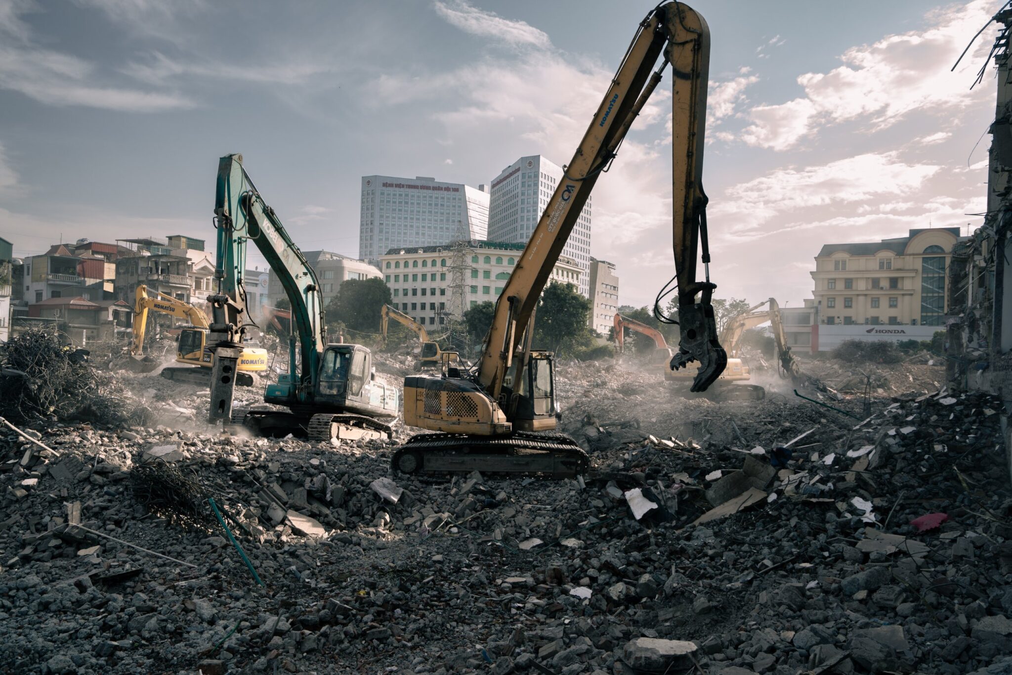 Excavators working across the demolition field